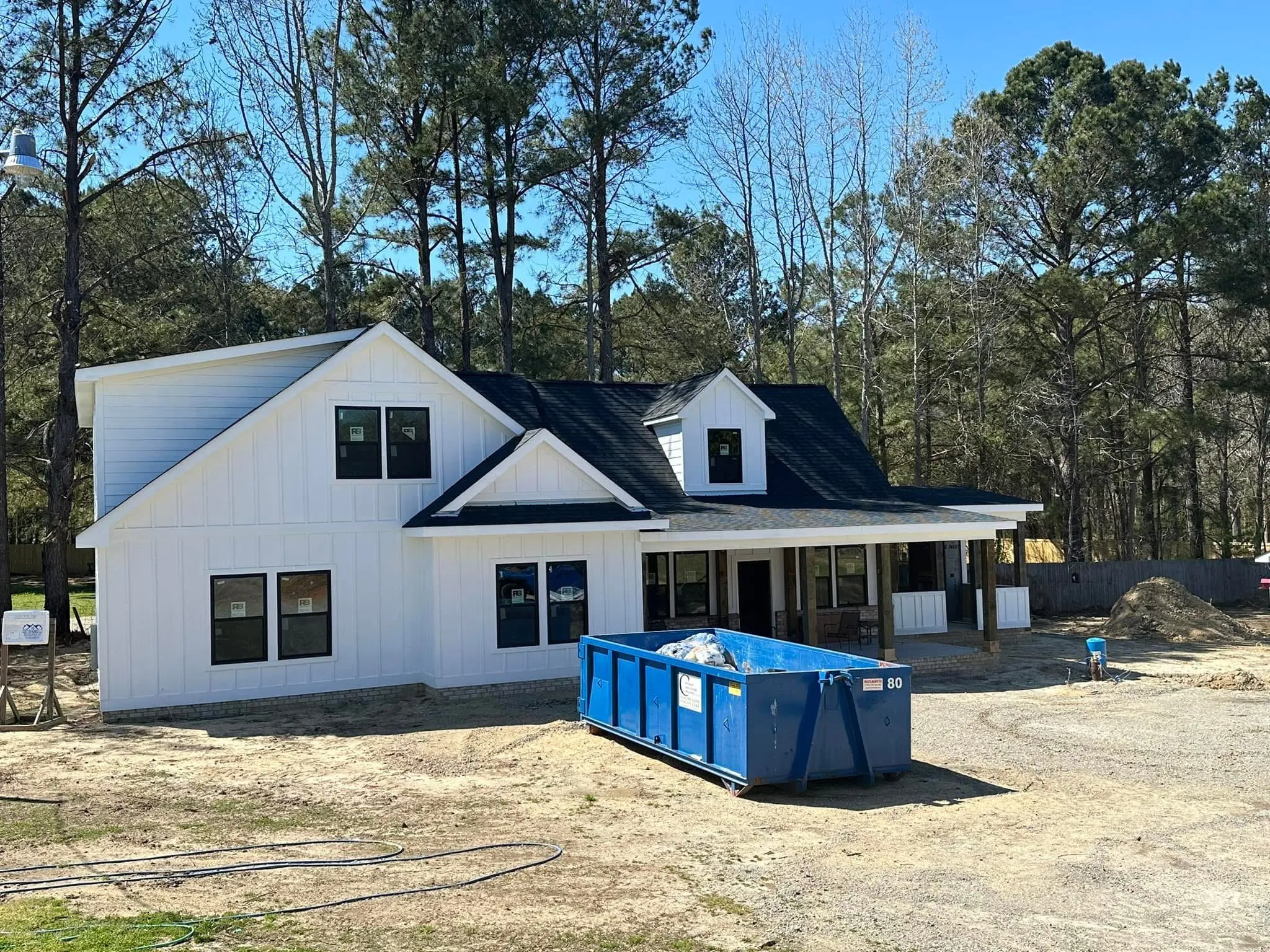 The modern farmhouse under construction matching the drawing