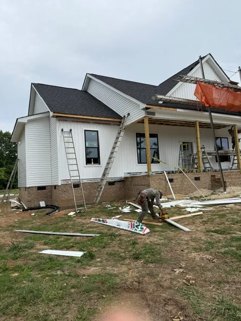 3-G Custom Homes crew installing siding on a new modern farmhouse