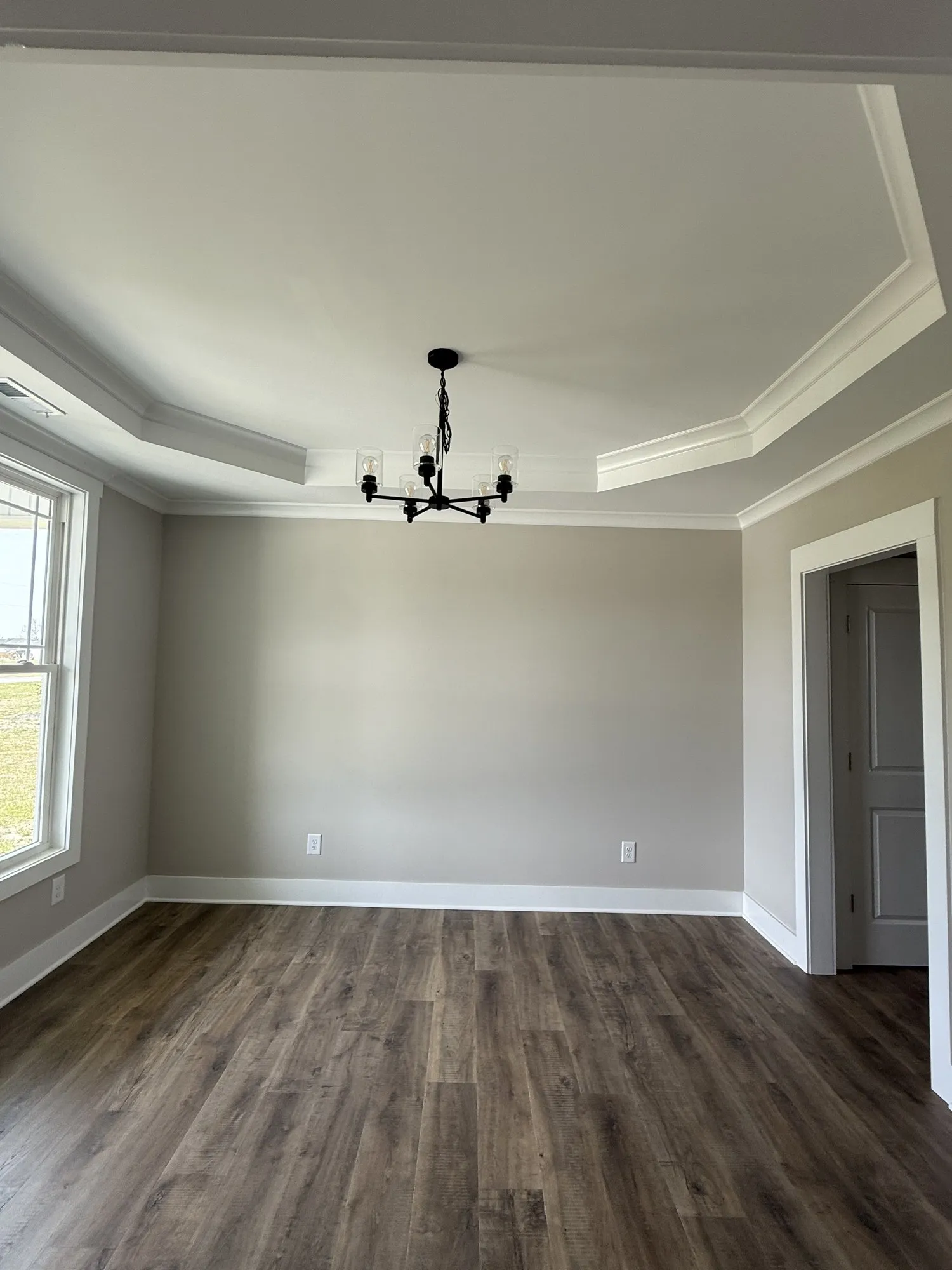 Dining room with tray ceiling and chandelier