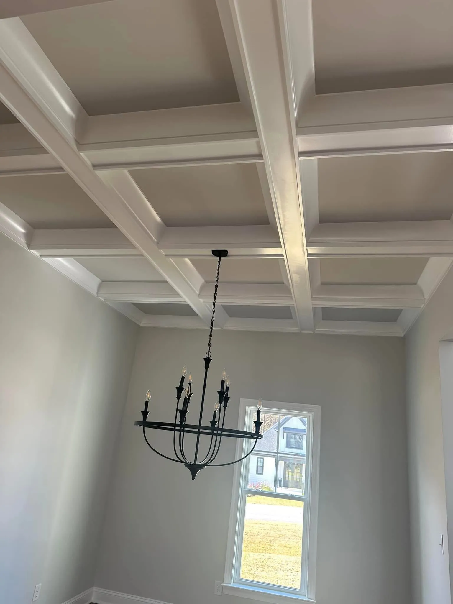 Dining room with coffered ceiling and chandelier