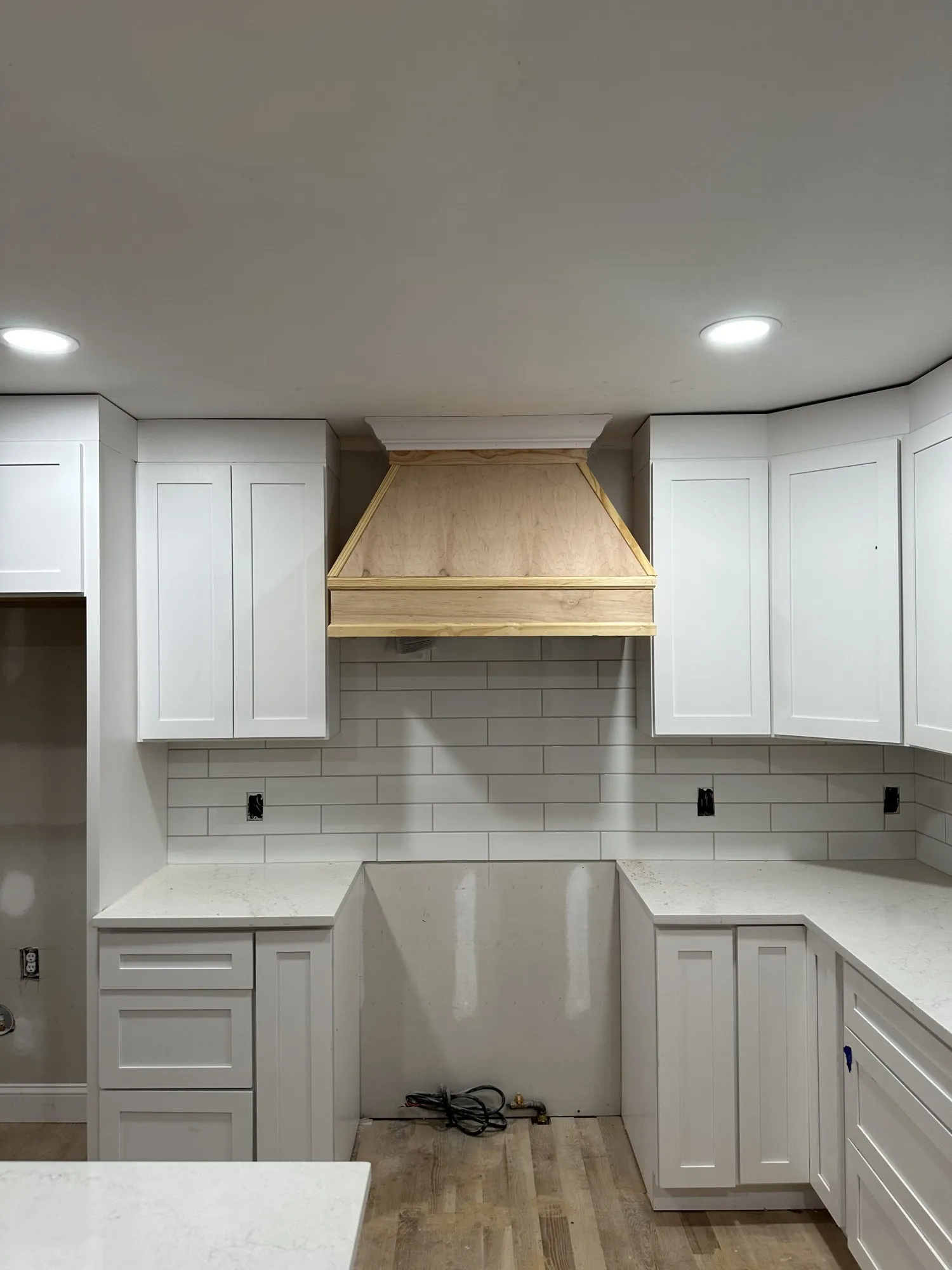 Custom kitchen with a wood range hood