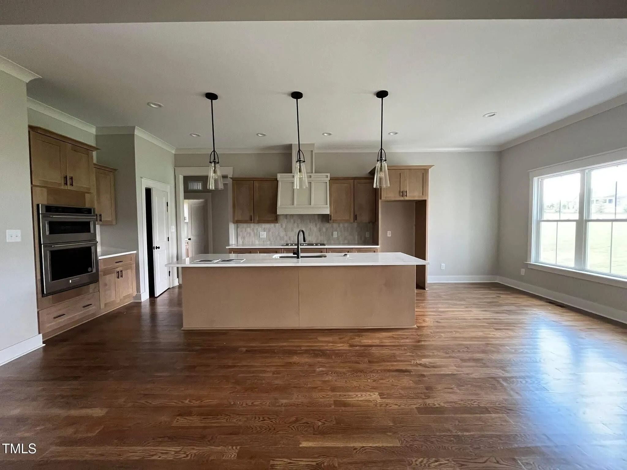 Open-concept custom kitchen with island and pendant lighting