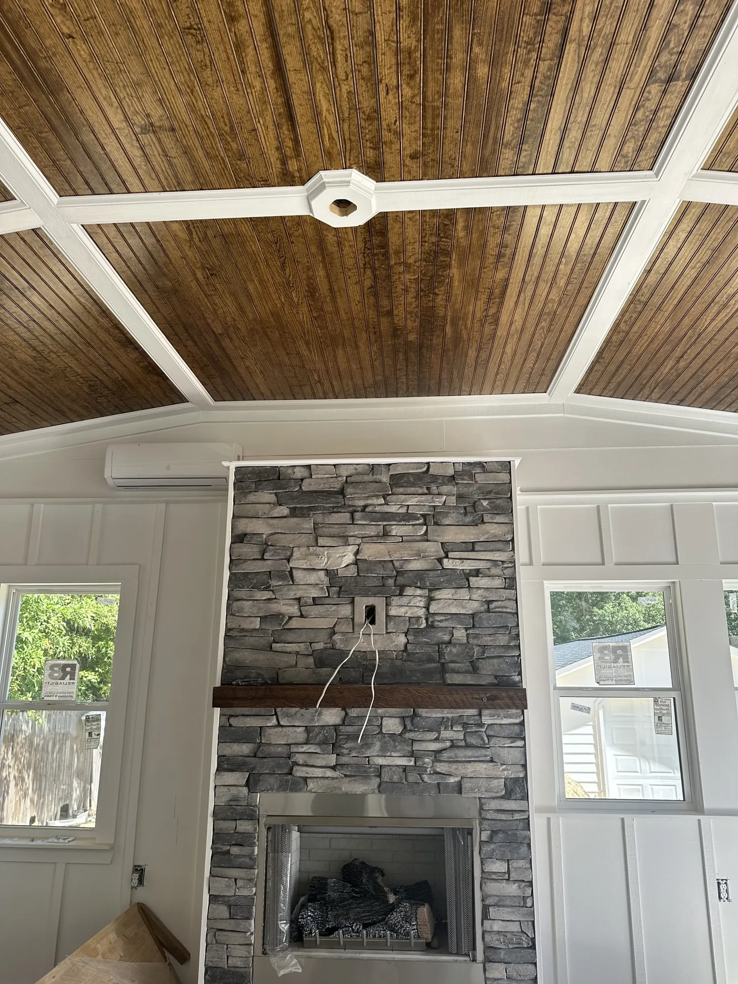 Living room with floor-to-ceiling stacked-stone fireplace