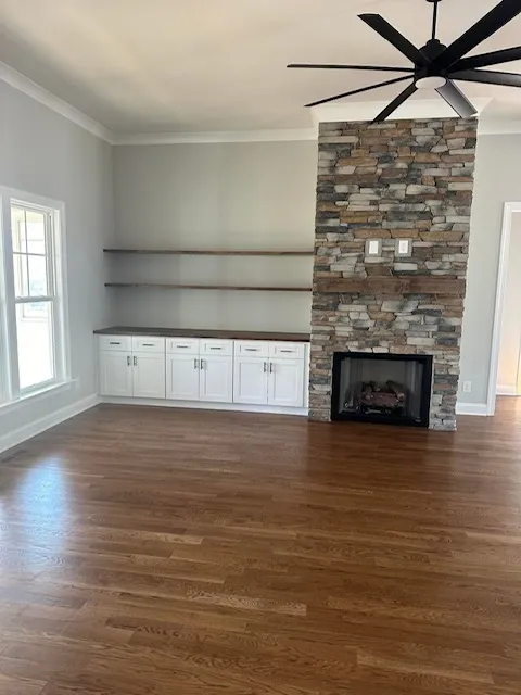 Living room with floor-to-ceiling stone fireplace and built-ins